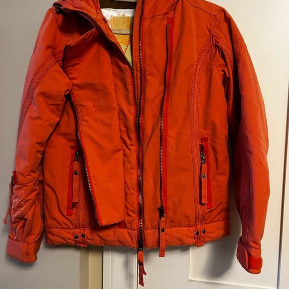 Obermeyer ski jacket in orange with brown lining. Lots of pockets, zipper front. - Picture 2 of 4